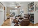 Relaxing living area with leather recliners, hardwood floors, and views to the dining area at 1164 W 101St Pl, Northglenn, CO 80260