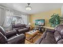 Inviting living room with hardwood floors, ample natural light, and comfortable seating at 1164 W 101St Pl, Northglenn, CO 80260