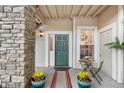 Inviting front porch with stone accents, decorative plants, and a cozy seating area at 4085 S Crystal Cir # 101, Aurora, CO 80014