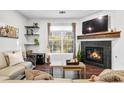 Comfortable living room with stone fireplace, large windows, and cozy sofa at 4085 S Crystal Cir # 101, Aurora, CO 80014