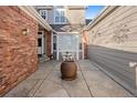 Inviting courtyard with brick accents, seating, and a large decorative pot at 9875 Greensview Cir, Lone Tree, CO 80124