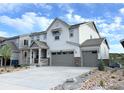 Charming two-story home with a three-car garage and inviting covered front porch at 3955 Descent St, Castle Rock, CO 80108