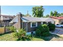 Side view of a brick ranch home showcasing a well-maintained exterior and landscaping at 7609 Sherman Pl, Denver, CO 80221