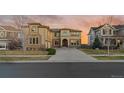 Charming two story stucco home with a concrete driveway and a meticulously maintained front lawn at 26656 E Peakview Dr, Aurora, CO 80016