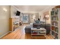 Cozy living room with hardwood floors, a fireplace, large sectional sofa, and a window hammock at 3905 E 2Nd Ave # 2, Denver, CO 80206