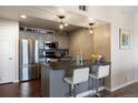 Charming kitchen with gray cabinetry, stainless steel appliances, and a breakfast bar at 12762 Ironstone Way # 302, Parker, CO 80134