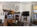 Inviting living room featuring a cozy fireplace, modern decor, and an open layout to the kitchen at 12762 Ironstone Way # 302, Parker, CO 80134