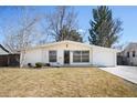 Inviting single-story home with a manicured lawn and classic white exterior with attached garage at 1360 S Hudson St, Denver, CO 80222