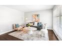 Bright and airy living room features stylish furnishings, accent rug and a modern aesthetic at 1360 S Hudson St, Denver, CO 80222
