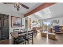 Bright living room featuring a skylight, wood beam, and hardwood floors at 10150 E Virginia Ave # 11-202, Denver, CO 80247