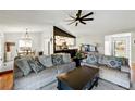 Inviting living room featuring hardwood floors, open layout, stylish furnishings, and a ceiling fan at 9664 W Grand Ave, Littleton, CO 80123