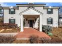 Elegant front entrance with a brick walkway, white columns and a covered porch at 2 Sterling Ave, Cherry Hills Village, CO 80113