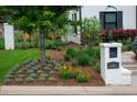 Professionally landscaped front yard with manicured lawn, flowerbeds, and a charming mailbox pillar at 2 Sterling Ave, Cherry Hills Village, CO 80113