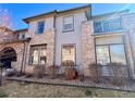 Attractive townhouse showcasing brick accents, large windows, and a charming balcony at 6725 S Winnipeg Cir # 106, Aurora, CO 80016