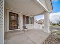 Covered front porch featuring classic architectural details and a comfortable seating area at 5178 Netherland St, Denver, CO 80249