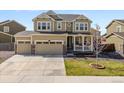 Beautiful two-story home boasts a three-car garage and a welcoming front porch at 6642 E 135Th Ave, Thornton, CO 80602