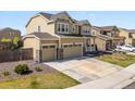Attractive two-story home featuring a three-car garage, manicured lawn, and welcoming front porch at 6642 E 135Th Ave, Thornton, CO 80602