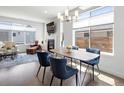 Bright dining area with modern lighting, comfortable seating, and a cozy fireplace in the background at 1568 Wolff St, Denver, CO 80204