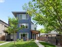 Modern, three-story home with sleek design and manicured front yard at 1568 Wolff St, Denver, CO 80204