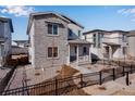 Beautiful two-story home featuring stone accents, a covered porch, and landscaped front yard at 3324 N Haleyville Ct, Aurora, CO 80019