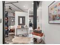 Stylish hallway with vintage luggage and decor, open to bedroom at 2500 Walnut St # 106, Denver, CO 80205