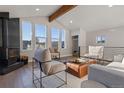 A bright living room with a wood-burning stove and large windows with expansive views at 11725 Tomahawk Trl, Conifer, CO 80433