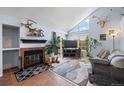 Charming living area featuring a cozy fireplace and lots of natural light from a large window at 4086 S Carson St # F, Aurora, CO 80014