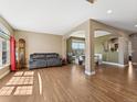 Spacious living room with hardwood floors, neutral walls, and abundant natural light at 7869 Solstice Way, Castle Rock, CO 80108