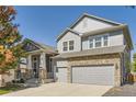 Charming two-story home with a stone accents, a spacious driveway, and manicured landscaping in a desirable neighborhood at 23029 Cleveland Dr, Parker, CO 80138