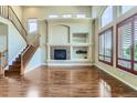 Bright living room featuring a fireplace, vaulted ceilings, and large windows with plantation shutters at 23029 Cleveland Dr, Parker, CO 80138