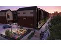 Charming townhome exteriors with modern amenities including landscaped patio, cozy firepit seating area, and convenient parking at 2 Ascent Trl, Englewood, CO 80112