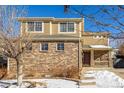 Two-story house with brick and siding, two-car garage, and covered porch at 3012 S Jericho Way, Aurora, CO 80013