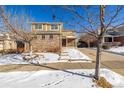 Two-story house with brick and siding, two-car garage, and covered porch at 3012 S Jericho Way, Aurora, CO 80013