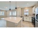 Bright, open kitchen with a large island, stainless steel appliances, and modern finishes at 6906 Kendrick Ln, Arvada, CO 80007