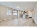 Sunlit open floor plan featuring modern kitchen with a large island, and spacious living area at 6906 Kendrick Ln, Arvada, CO 80007