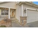 House exterior showcasing front entrance and stone accents at 303 Tumbleweed Dr, Brighton, CO 80601