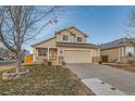 Charming two-story home with attached garage and landscaped yard at 303 Tumbleweed Dr, Brighton, CO 80601