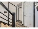 Hallway with wood-look tile flooring and white doors trimmed in black at 17652 E Temple Dr, Aurora, CO 80015