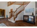 Grand foyer with a beautiful wooden staircase, hardwood floors, and modern decor at 5699 Northwood Dr, Evergreen, CO 80439