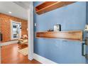 Stylish entryway featuring wood accents and exposed brick detail at 1208 S Pennsylvania St, Denver, CO 80210