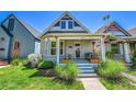Charming home featuring a quaint front porch and well-maintained landscaping for a welcoming curb appeal at 1208 S Pennsylvania St, Denver, CO 80210