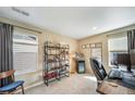 Bedroom with beige walls, two windows, and a large dark bookcase displaying books and collectables at 11442 Booth Falls Ct, Parker, CO 80134