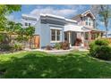 Blue single-Gathering home with manicured lawn, fenced yard, and mature trees at 2643 N Marion St, Denver, CO 80205