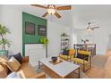 Inviting living room featuring bright yellow chairs, modern decor, and hardwood floors at 2643 N Marion St, Denver, CO 80205
