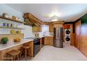 Modern kitchen featuring stainless steel appliances, a marble countertop, and stylish wooden cabinetry at 4580 Balsam St, Wheat Ridge, CO 80033