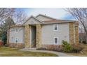 Charming condo exterior with stone accents and inviting entryway staircase at 7656 Depew St # 1802, Arvada, CO 80003
