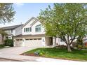 Charming two-story home with three-car garage and well-manicured lawn at 9574 Las Colinas Dr, Lone Tree, CO 80124