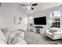 Bright living room with vaulted ceilings, plush carpeting, and modern decor at 9574 Las Colinas Dr, Lone Tree, CO 80124