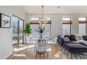 Sunlit dining area with glass table, modern chairs, and large windows offering pleasant views at 1080 E 13Th Ave # 301, Denver, CO 80218