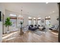 Sunlit living room with hardwood floors, a modern rug, and comfortable seating at 1080 E 13Th Ave # 301, Denver, CO 80218